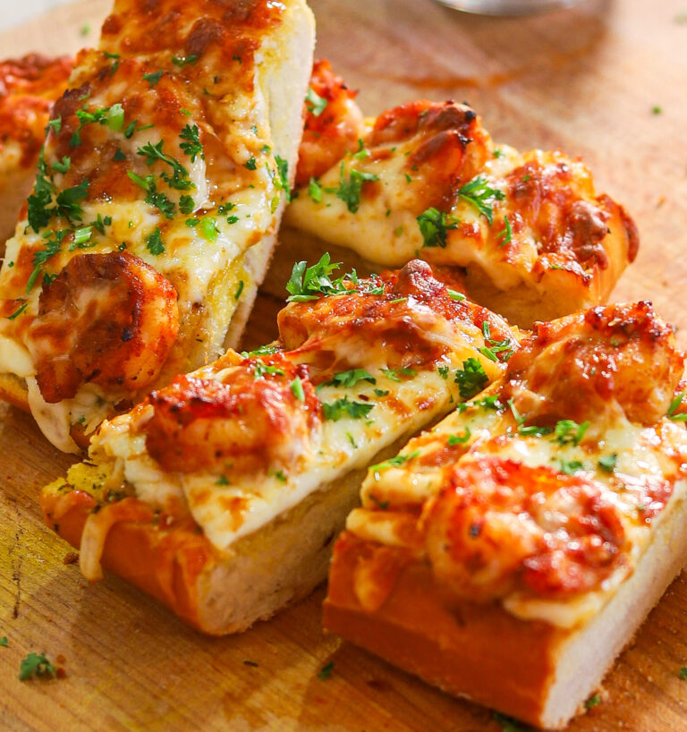 Cajun Shrimp Garlic Bread sliced on a wooden cutting board