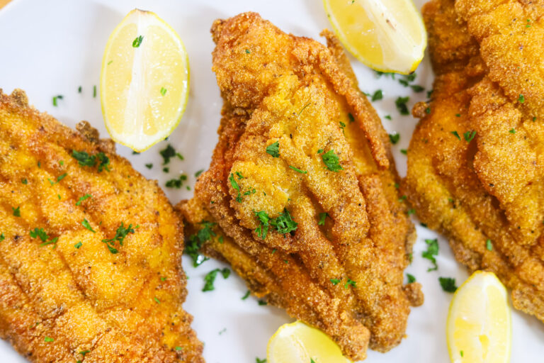 Southern fried catfish served with lemon wedges and hot sauce